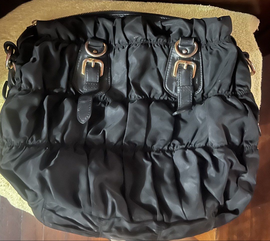 Prada Black Ruched Tote Bag - PROJECT bag!!! (Category: Luxury Bags & Wallets) located in Daraga. Submitted by pickandgo26 (Listing ID 1468767801, Image 2). Description: Clean inside and out. Missing handles and sling and one zipper puller of the main compartment. Lampo zip Pls see actual pics for reference..