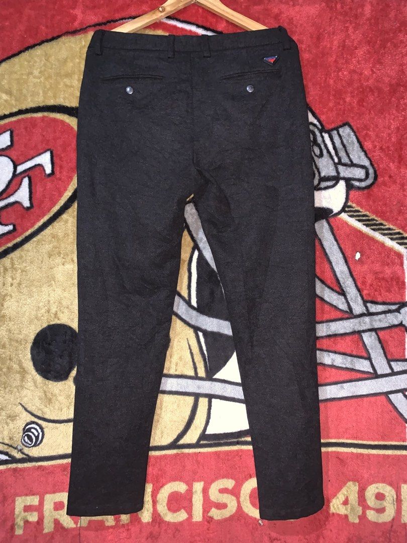 Prada Black Wool-Blend Tailored Trousers (Category: Trousers) located in Tayug. Submitted by cvcthrift (Listing ID 1468919834, Image 3). Description: W-33-34 L-39 NO ISSUE EXCELLENT CR-9.5/10 - Brand: Prada - Color: Dark grey - Material: Premium wool-blend - Fit: Slim cut leg with structured tailoring - Details: Front button closure with Prada branding, back welt pockets with button closure - Branding: Iconic small triangular logo plaque on back 