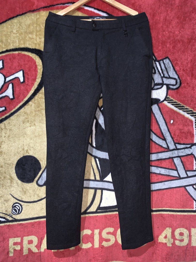 Prada Black Wool-Blend Tailored Trousers (Category: Trousers) located in Tayug. Submitted by cvcthrift (Listing ID 1468919834, Image 2). Description: W-33-34 L-39 NO ISSUE EXCELLENT CR-9.5/10 - Brand: Prada - Color: Dark grey - Material: Premium wool-blend - Fit: Slim cut leg with structured tailoring - Details: Front button closure with Prada branding, back welt pockets with button closure - Branding: Iconic small triangular logo plaque on back 