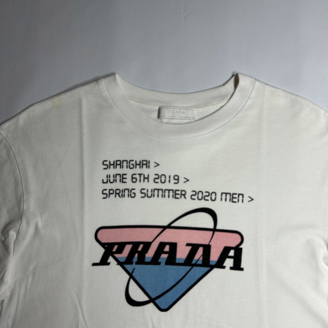 Prada Shanghai Exclusive Shirt (Category: Tshirts & Polo Shirts ) located in Antipolo. Submitted by wvyfrnds (Listing ID 1468743501, Image 2). Description: Prada Shanghai Exclusive Shirt Size: S Color: White Dimensions (Inches): Length: 25.5 Width: 19.5 Color Rate: 9/10 Issues - Light stains 395 PLUS SF.