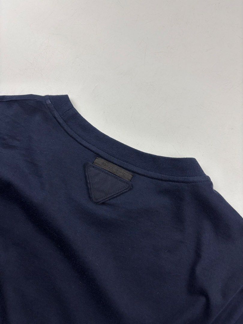 Prada Triangle Patch T-Shirt (Category: Tshirts & Polo Shirts ) located in Makati City. Submitted by ragrepository (Listing ID 1468730867, Image 3). Description: Prada Triangle Patch T-Shirt Tagged as Large Length- 27.5” Pit to pit- 20” Sleeves- 7.5” Shoulder-17.5” Condition-9/10 Flaw- None .