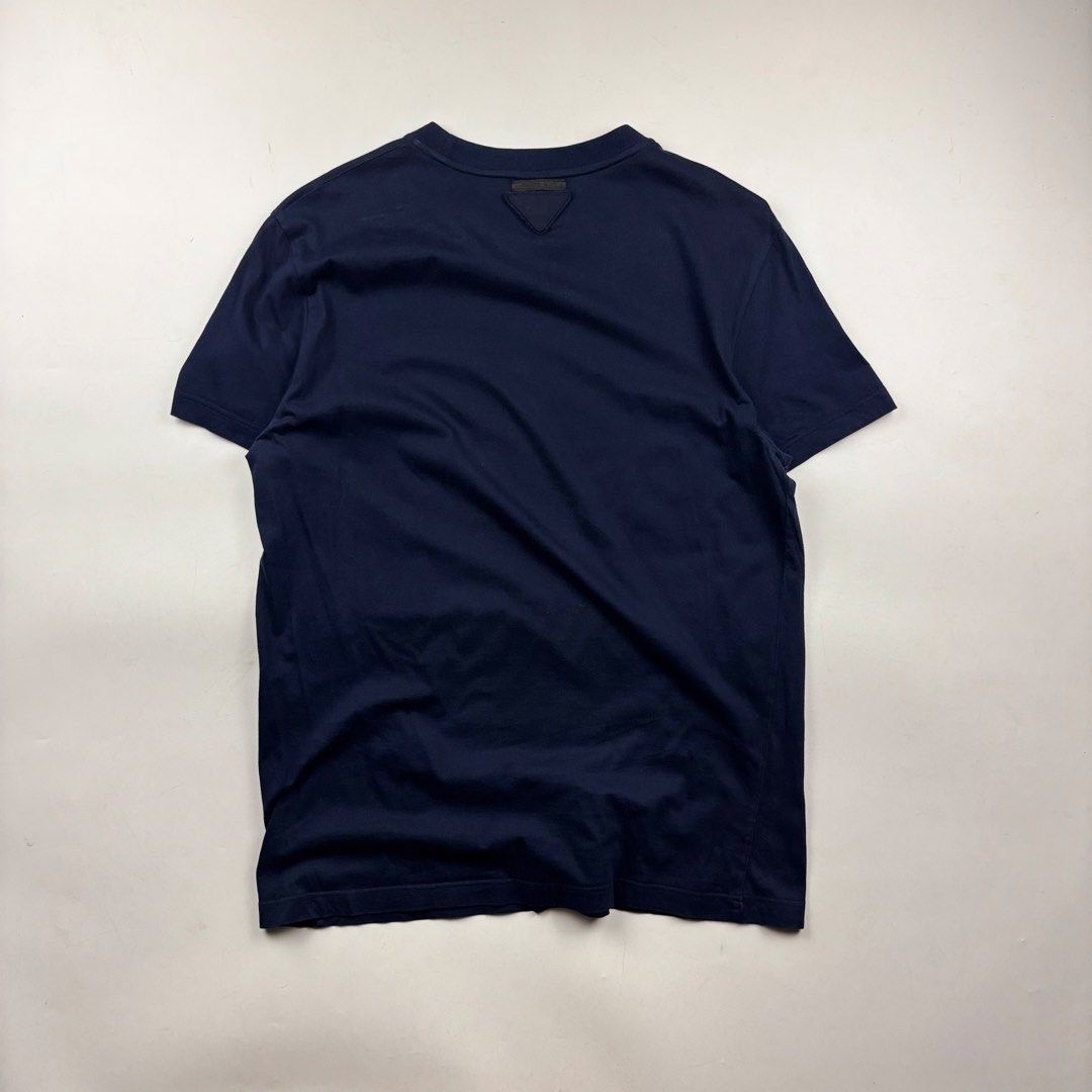 Prada Triangle Patch T-Shirt (Category: Tshirts & Polo Shirts ) located in Makati City. Submitted by ragrepository (Listing ID 1468730867, Image 2). Description: Prada Triangle Patch T-Shirt Tagged as Large Length- 27.5” Pit to pit- 20” Sleeves- 7.5” Shoulder-17.5” Condition-9/10 Flaw- None .