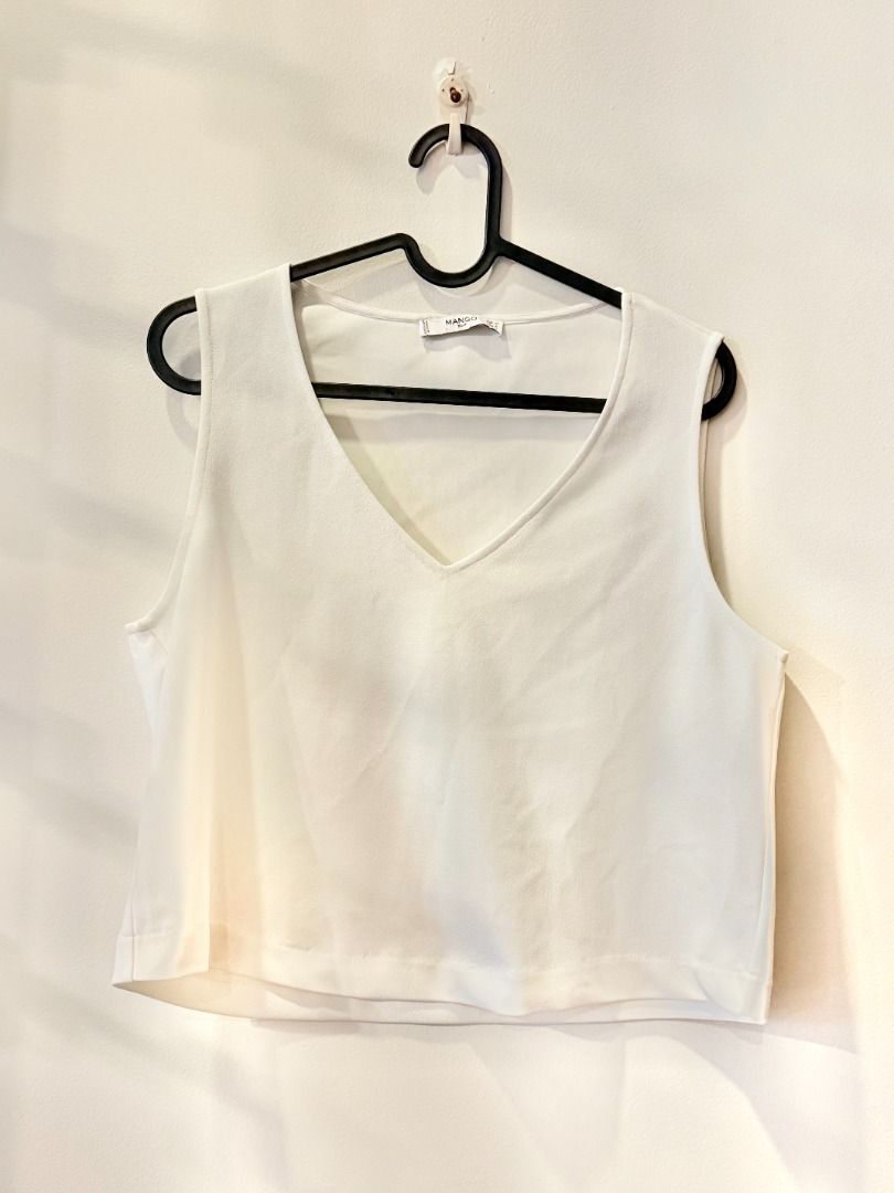 Preloved MANGO White V-Neck Sleeveless Top (Category: Sleeveless) located in Taguig. Submitted by mandady (Listing ID 1468797153, Image 1). Description: Classic minimalist white top with a flattering V-neckline and sleeveless design. Easy to style with trousers, jeans, or skirts for casual and smart-casual outfits. Brand: MANGO Color: White Condition: Preloved.