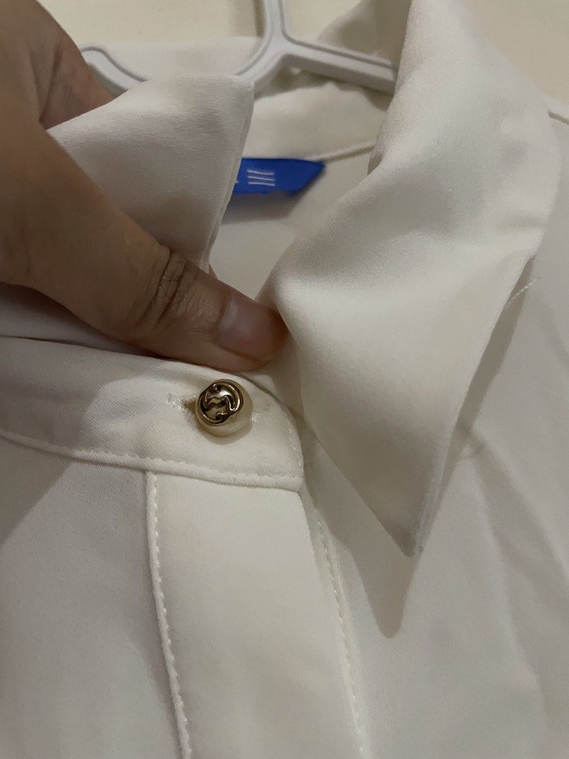 White Ruffle Button Down Long Sleeve Blouse (Category: Blouses) located in Makati City. Submitted by nikarchives (Listing ID 1468747485, Image 2). Description: Psalter white blouse with pleated ruffles along the front placket. Long sleeves featuring black cuffs with gold buttons. Collared neckline, button-up closure down the center. Size tag reads 36..