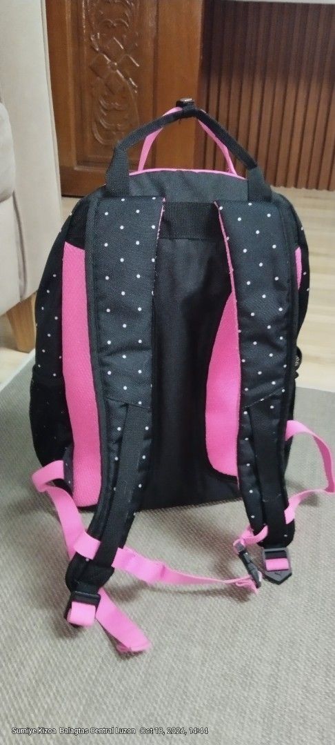Puma Black and Pink Polka Dot Backpack (Category: Backpacks) located in Guiguinto. Submitted by ambershelb75728 (Listing ID 1468769899, Image 2). Description: - Brand: Puma - Design: Black with white polka dots and bright pink accents - Comfort: Dual top carry handles and adjustable padded shoulder straps - Storage: Main zippered compartment, front zippered pocket, and side mesh pockets - Interior: Vibrant pink lining with durable black base pane