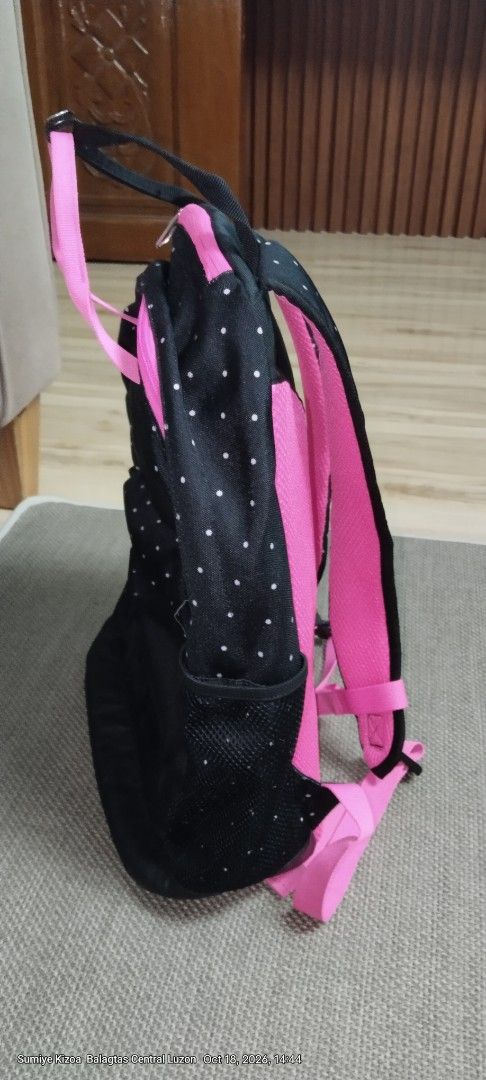 Puma Black and Pink Polka Dot Backpack (Category: Backpacks) located in Guiguinto. Submitted by ambershelb75728 (Listing ID 1468769899, Image 3). Description: - Brand: Puma - Design: Black with white polka dots and bright pink accents - Comfort: Dual top carry handles and adjustable padded shoulder straps - Storage: Main zippered compartment, front zippered pocket, and side mesh pockets - Interior: Vibrant pink lining with durable black base pane