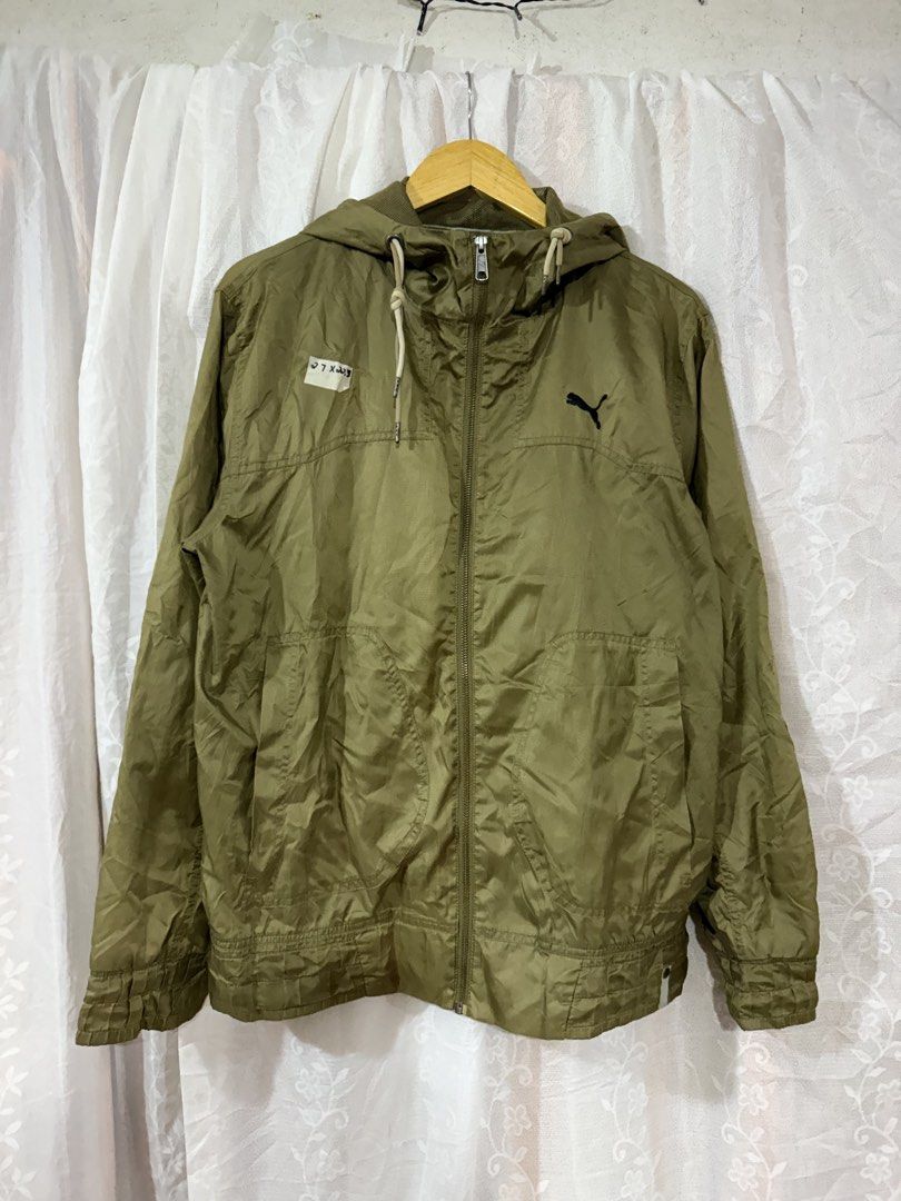 Puma Olive Green Hooded Windbreaker Jacket (Category: Coats, Jackets and Outerwear) located in Quezon City. Submitted by dapanaaaay (Listing ID 1468747443, Image 1). Description: - Brand: Puma - Color: Olive green - Condition: Brand new with tag attached on the chest - Features: Full zip front, drawstring hood, dual front pockets, elastic cuffs and hem - Logo: Embroidered black Puma cat logo on the chest - Material: Lightweight, ideal for breezy 