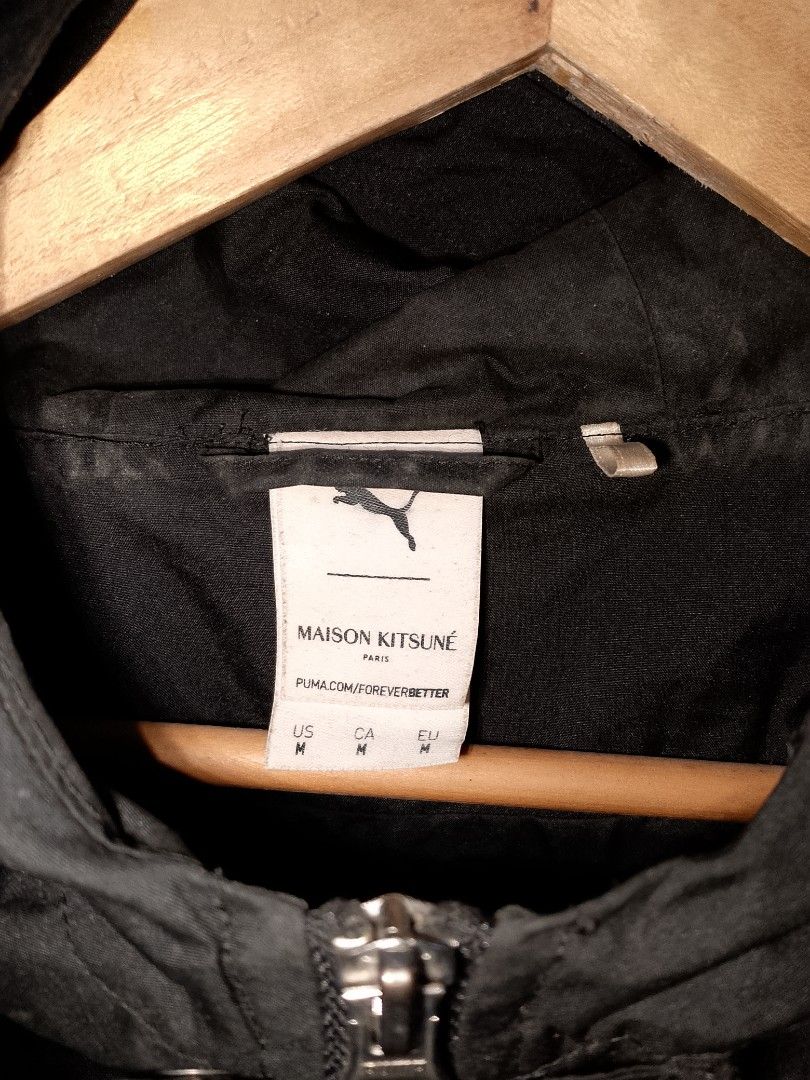 Puma x Maison Kitsune Black Zip Jacket (Category: Coats, Jackets and Outerwear) located in Manila. Submitted by mjthrifted_second (Listing ID 1468734728, Image 2). Description: - Brand: Puma x Maison Kitsuné Collaboration - Color: Classic Black - Size: Medium (US, CA, EU standard) -Dimes: 25/28 - Features: Full zip front with an adjustable hood - Design: Clean minimalist aesthetic with an exclusive co-branded label inside the collar - Condition: 