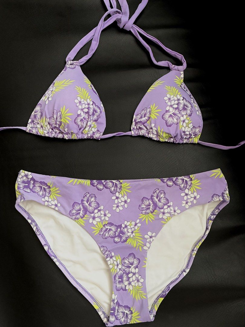 Purple Floral Halter Bikini Set (Category: Bikinis & Swimsuits) located in Tanauan. Submitted by theitgirlsdibs4 (Listing ID 1468738873, Image 2). Description: - Style: Tropical lilac bikini set with purple and white hibiscus flowers and lime green leaves - Top: Halter style with adjustable tie straps for a custom fit - Bottoms: High-waisted with full coverage and clean white inner lining - Ideal For: Beach trips, pool parties, and tropical getaw