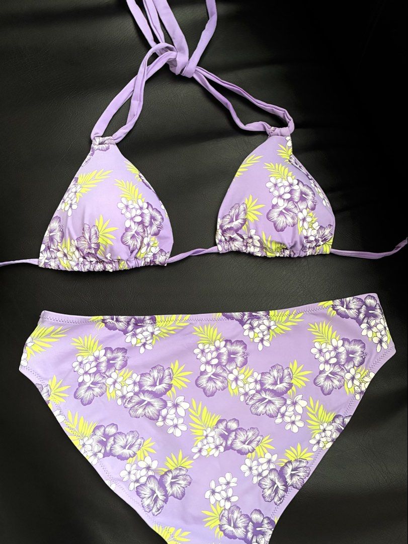 Purple Floral Halter Bikini Set (Category: Bikinis & Swimsuits) located in Tanauan. Submitted by theitgirlsdibs4 (Listing ID 1468738873, Image 1). Description: - Style: Tropical lilac bikini set with purple and white hibiscus flowers and lime green leaves - Top: Halter style with adjustable tie straps for a custom fit - Bottoms: High-waisted with full coverage and clean white inner lining - Ideal For: Beach trips, pool parties, and tropical getaw