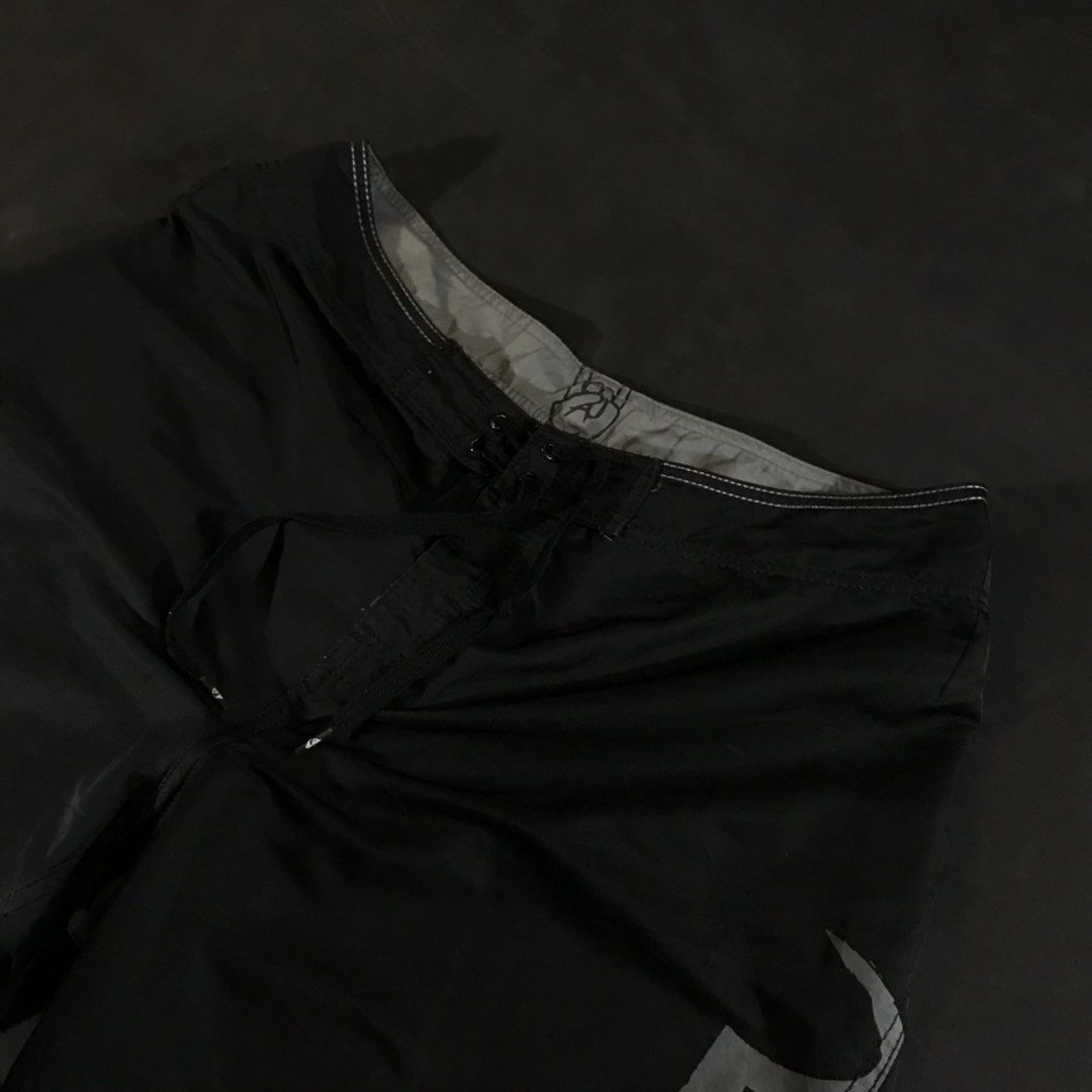 Quiksilver Board Shorts (Category: Swim Trunks & Board Shorts) located in Manila. Submitted by a_aron.f6e3a7 (Listing ID 1468787807, Image 2). Description: Size: W19 L22 • Color rate: 9/10 (Black with White Quiksilver Logo and White Hem Details) • Condition: Good pre-owned condition • Issues: Visible wrinkles and creases; slight fraying or wear may be present along the bottom hem.