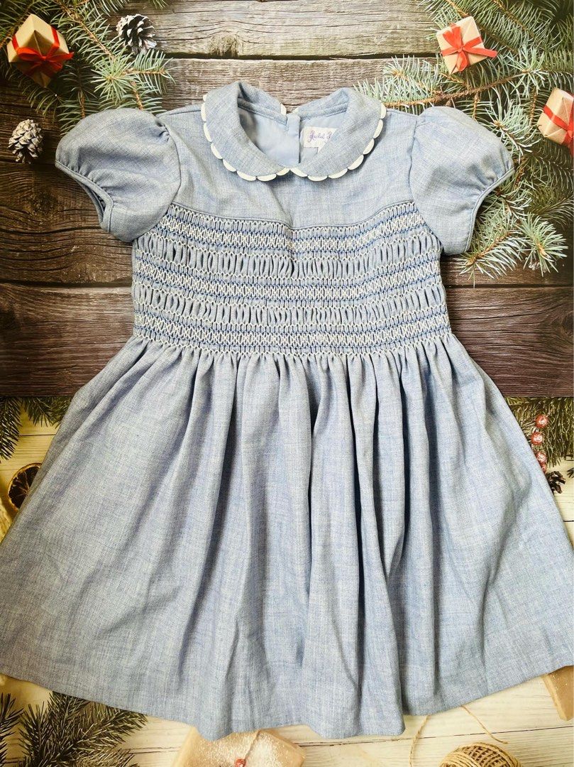 Rachel Riley Blue Smocked Dress with Collar (Category: Babies & Kids Fashion) located in Antipolo. Submitted by mlingc19 (Listing ID 1468856423, Image 1). Description: - Color: Light blue - Design: Hand-smocked chest, white scalloped Peter Pan collar - Sleeves: Short puff sleeves with gathered cuffs - Skirt: Flared with soft pleats - Closure: Back button closure with authentic brand label - Condition: Excellent, well-maintained - Shipping: Fast s