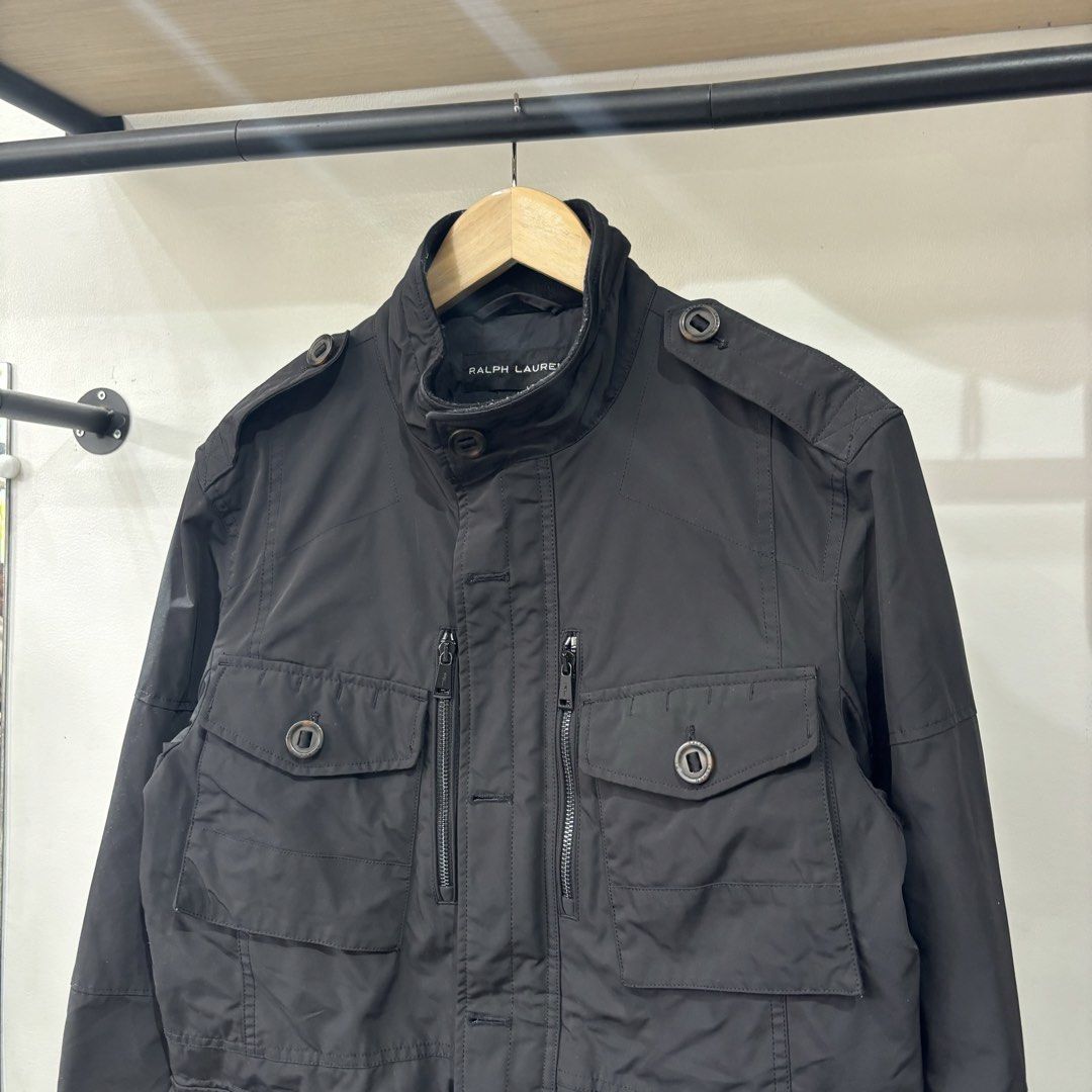 Ralph Lauren Black Utility Jacket with Multiple Pockets (Category: Coats, Jackets and Outerwear) located in Bambang. Submitted by heats777 (Listing ID 1468827917, Image 1). Description: - Brand: Ralph Lauren - Color: Black - Material: Durable nylon - Closure: Full zip front with snap button storm flap - Collar: Stand collar with shoulder epaulets - Pockets: Four front flap pockets and two vertical zippered chest pockets - Details: Branded hardwar