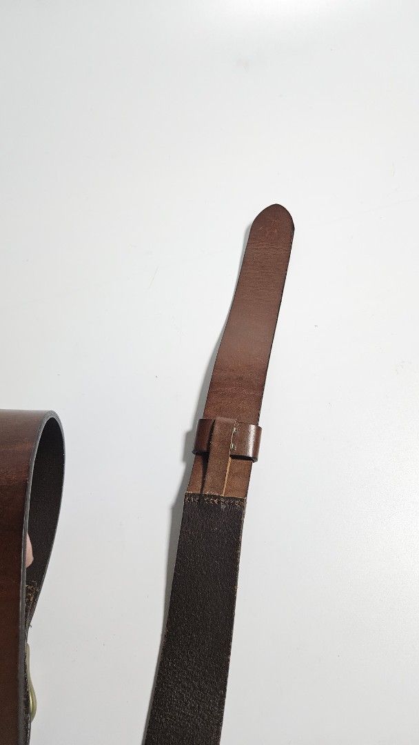 Ralph Lauren Dark Brown Leather Belt (Category: Belts) located in Alfonso. Submitted by jbcamet (Listing ID 1468885018, Image 3). Description: - Brand: Ralph Lauren - Color: Dark Brown - Material: 100% Genuine Leather with solid stitching - Hardware: Heavy-duty brass-tone with unique buckle design - Authenticity: Debossed brand logo and serial number stamped on inner strap - Condition: Clean finish, ready to wear.