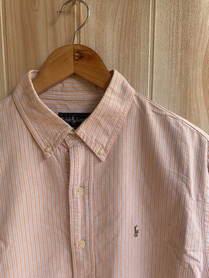 Ralph Lauren Orange Striped Button Down Shirt 16-31 (Category: Tshirts & Polo Shirts ) located in Barobo. Submitted by pammythrift (Listing ID 1468754766, Image 3). Description: - Brand: Ralph Lauren - Design: Orange and white stripes with blue pinstripes - Details: Button-down collar, front button closure, and iconic embroidered pony logo on the chest pocket - Material: 100% lightweight and breathable cotton - Origin: Made in Hong Kong - Size: F