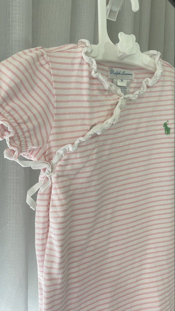 ralph lauren romper (Category: Babies & Kids Fashion) located in Manila. Submitted by louiesalvador (Listing ID 1468716724, Image 3). Description: • brand: ralph lauren • size: 9 months on tag • light pink and white stripes • side wrap style with tie closure and snap buttons for easy diaper changes • white lace trim on the collar and opening, ruffled short sleeves, and small green embroidered logo on the chest.