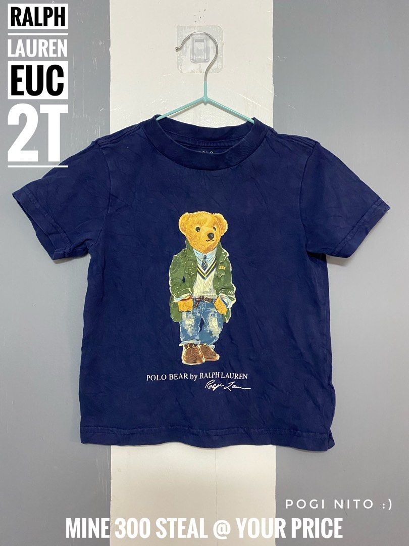 Ralph Lauren shirt (Category: Babies & Kids Fashion) located in Paranaque City. Submitted by shiney10 (Listing ID 1468837003, Image 1). Description: - Brand: Ralph Lauren - Color: Navy Blue - Size: 2T Toddler - Design: Iconic Polo Bear graphic in green jacket and jeans - Material: Soft 100% cotton - Details: Short sleeves, classic crew neck - Condition: Great everyday basic for little ones.