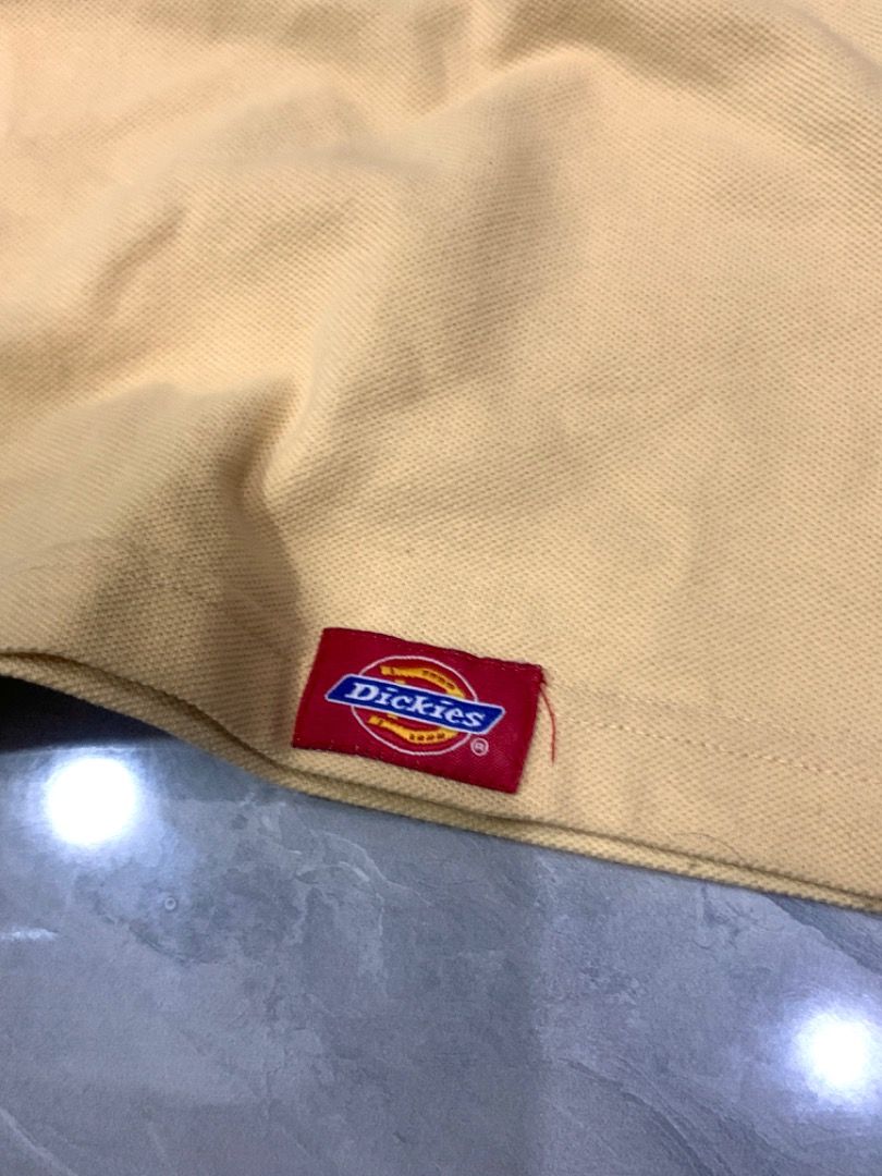 RARE Dickies Polo (Category: Tshirts & Polo Shirts ) located in Tarlac. Submitted by thriftniaki (Listing ID 1468858365, Image 2). Description: - Dickies Polo Shirt - Color: Light Yellow - Size: XL (USA Tag) - Features: Unique gothic-style embroidered chest logo, woven hem label - Condition: Pre-owned, vintage condition (needs wash) - Style: Casual / Streetwear.
