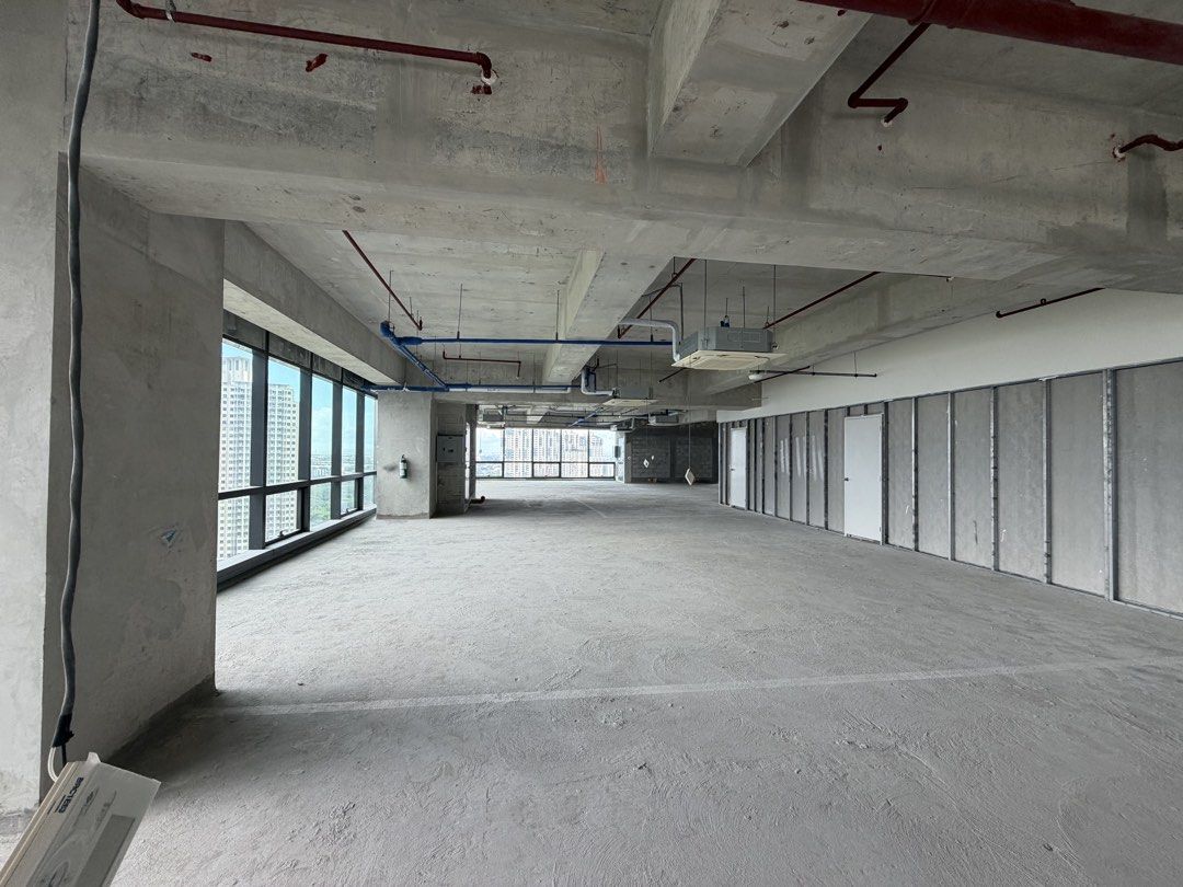 Raw Bare Shell Commercial Office Space For Lease (Category: Commercial) located in Marikina City. Submitted by jimwelllop94038 (Listing ID 1468724329, Image 3). Description: - Bare shell office floor with a raw concrete finish - Open layout featuring pre-installed partition framing on one side - High industrial ceilings with exposed pipes, ducts, and sprinklers - Abundant natural light from large perimeter windows - Includes installed ceiling AC 