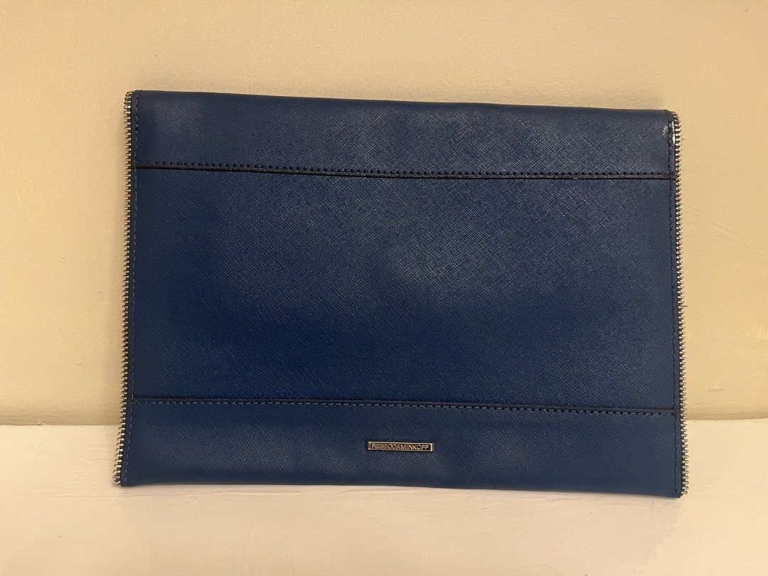 Rebecca Minkoff Blue Envelope Clutch Bag (Category: Luxury Bags & Wallets) located in Manila. Submitted by bellejnc (Listing ID 1468812870, Image 3). Description: - Brand: Rebecca Minkoff - Style: Envelope clutch - Material: Premium dark blue Saffiano leather - Hardware: Silver-tone zipper trim and metal back logo plate - Closure: Front envelope flap - Condition: Clean structure inside and out, minor scuff near zipper edge (see close-up photo) - 