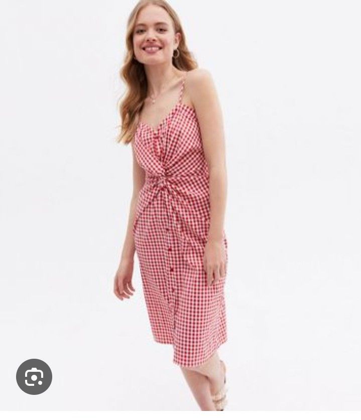 Red checkered dress (Category: Dresses) located in Manila. Submitted by wheneity67thifted (Listing ID 1468927362, Image 1). Description: This red-and-white gingham midi dress features a V-neckline, spaghetti straps, a twist-front/tie detail at the bust, and a button-front closure..