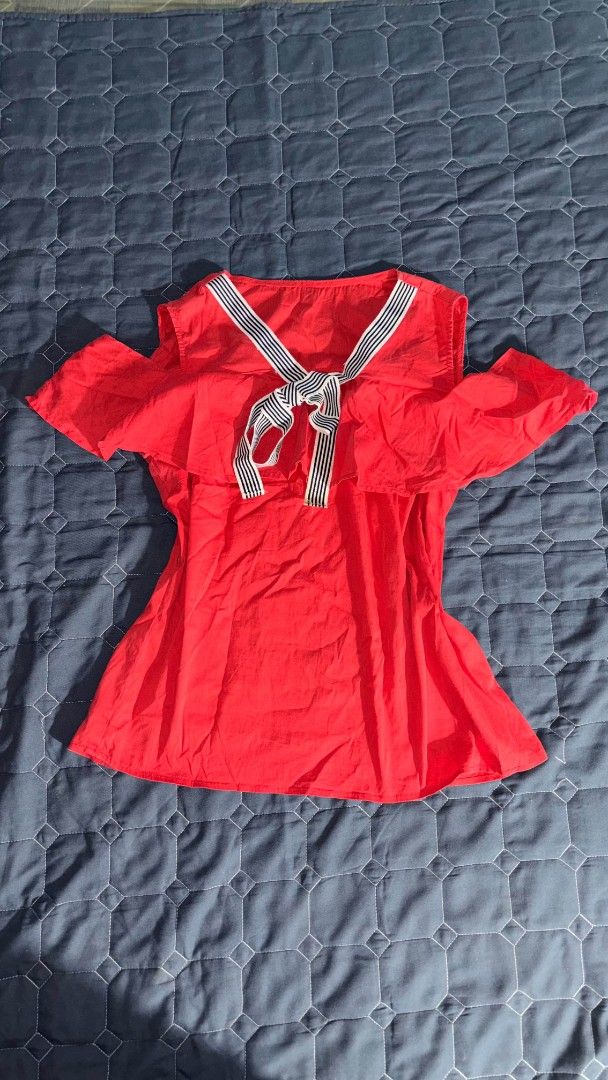 Red cold shoulder blouse with striped bow detail (Category: Blouses) located in Manila. Submitted by itz_zy (Listing ID 1468858202, Image 1). Description: - Color: Bright red - Style: Cold-shoulder top with short sleeves - Details: Large ruffle layer across the front and back, sailor-style striped ribbon tie at the neckline - Fabric: Lightweight and breathable - Perfect for: Casual days out, easily styled with jeans or shorts.