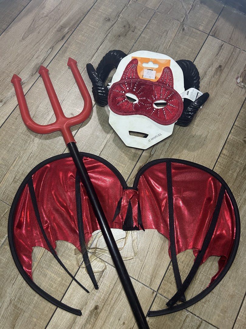 Red Devil Demon Costume Set Wings Trident Horns Mask (Category: Sets & Coordinates) located in Paranaque City. Submitted by zac.sei (Listing ID 1468898043, Image 1). Description: - Complete kids' devil costume set - Includes red wings, red trident prop, black ram horns headband, and a sparkly red sequin eye mask - Ideal for Halloween parties and dress-up events - Kids sizing indicated on packaging - Stored together and ready for your next event.