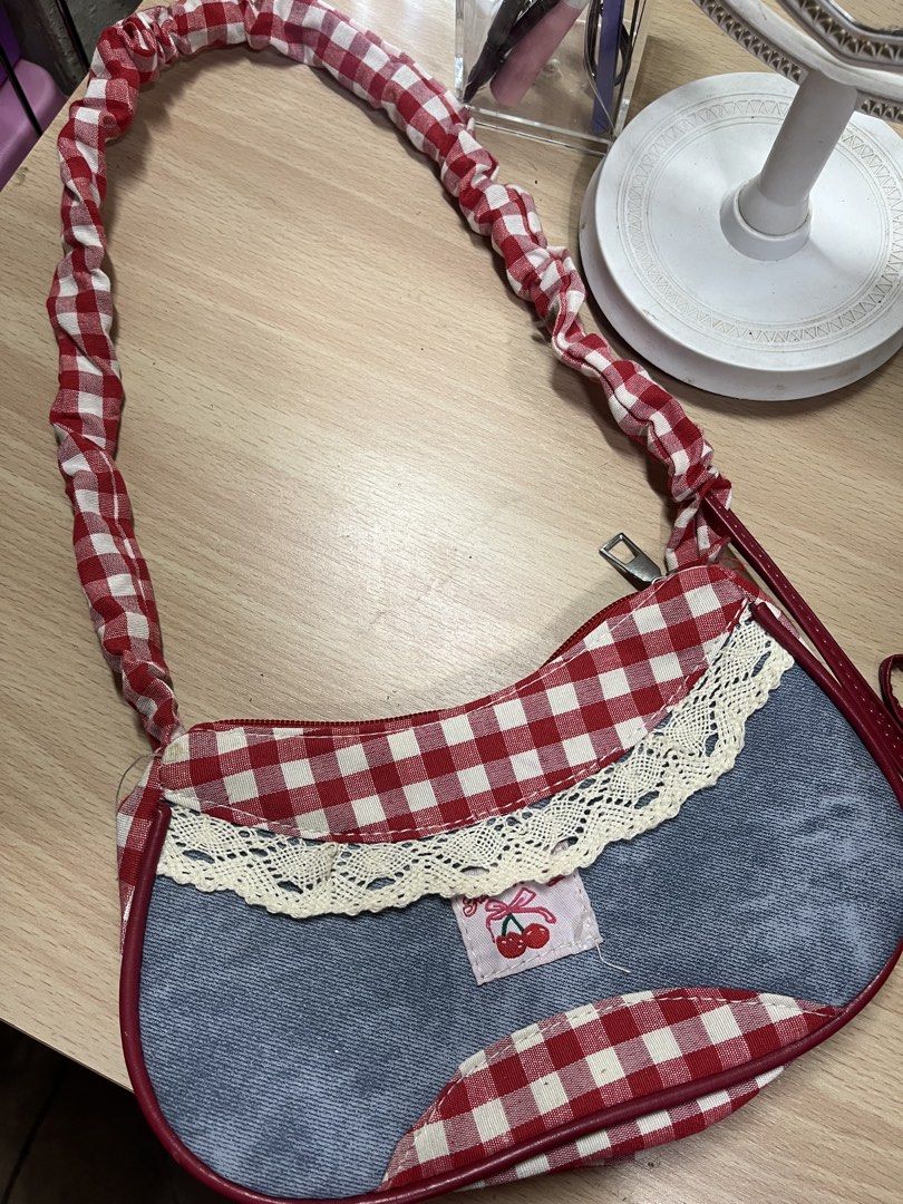 Red gingham and denim shoulder bag (Category: Shoulder Bags) located in Antipolo. Submitted by nominnnm (Listing ID 1468795483, Image 1). Description: Coquette gingham kili bag New. Never nagamit rfs: naka tambak lang sa bahay.