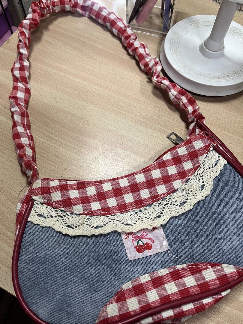 Red gingham and denim shoulder bag (Category: Shoulder Bags) located in Antipolo. Submitted by nominnnm (Listing ID 1468795483, Image 2). Description: Coquette gingham kili bag New. Never nagamit rfs: naka tambak lang sa bahay.