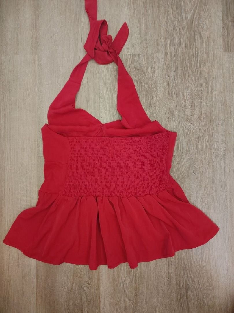 Red Halter Neck Peplum Top with Tie Back (Category: Sleeveless) located in Manila. Submitted by babeboxtheory (Listing ID 1468859594, Image 2). Description: - Color: Bright red - Style: Halter top with V-neck and structured under-bust seams - Fit: Stretchy smocked back panel and cute tie-back - Details: Flared, flowy peplum hem - Fabric: Lightweight and comfortable - Perfect for: Casual day wear or dressing up for a night out with jeans or a skir