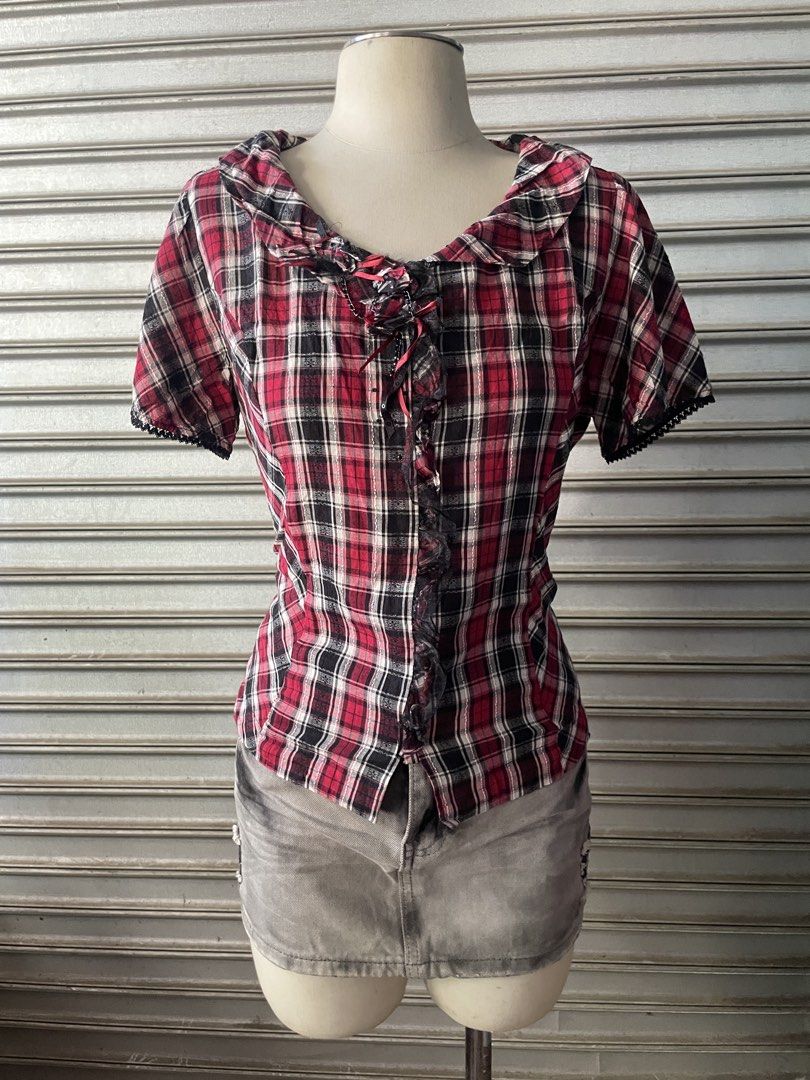 Red Plaid Short Sleeve Blouse with Ruffled Collar (Category: Blouses) located in Davao. Submitted by riab_qt (Listing ID 1468775142, Image 2). Description: - Color & Pattern: Red, black, and white plaid - Style: Vintage punk / fairy kei aesthetic - Details: Sailor-style ruffled collar, dark grey lace trim, and front button closure - Accents: Thin red ribbons, small metal chains on ruffles, and black lace edging on sleeve cuffs .