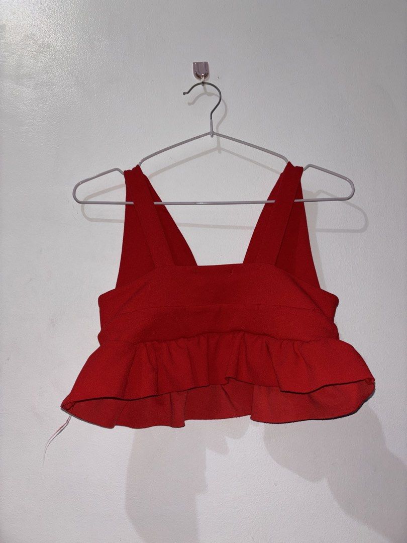Red plunge peplum crop top (Category: Others Tops) located in Manila. Submitted by sophia_blessy (Listing ID 1468722759, Image 2). Description: A deep V-neckline, wide tank straps, a fitted banded waist, and a flared, ruffled peplum hemline..