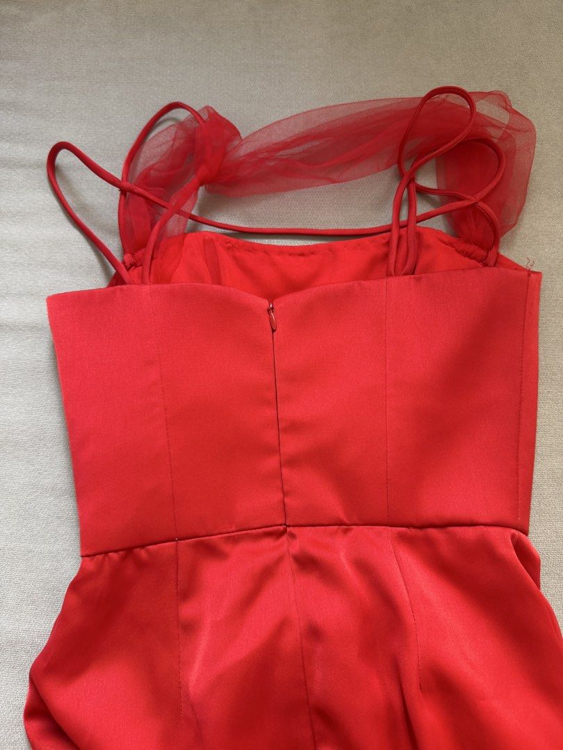 Red Satin Cocktail Dress (Category: Evening dresses & gowns) located in Manila. Submitted by expectopatronum934 (Listing ID 1468768053, Image 3). Description: - Designer: Ulysses Caragayan - Color: Bright red - Material: Heavy satin that holds its shape nicely - Size: Fits xsmal - Design: Fitted bodice, ruched skirt with front slit, delicate straps, and sheer tulle shoulder detail - Closure: Back zipper - Condition: Worn once, freshly cleaned and