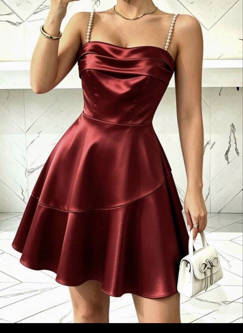 Red Satin Spaghetti Strap Mini Dress with Ruffle Hem (Category: Dresses) located in Caloocan City. Submitted by conanpearl (Listing ID 1468795709, Image 1). Description: - Color: Rich burgundy - Material: Smooth, glossy satin fabric with a flexible smocked back panel - Design: Elegant cowl neckline, beaded spaghetti straps, and a trendy layered ruffle skirt - Versatility: Ideal for parties, dinners, and nights out - Styling Tip: Easy to dress up 