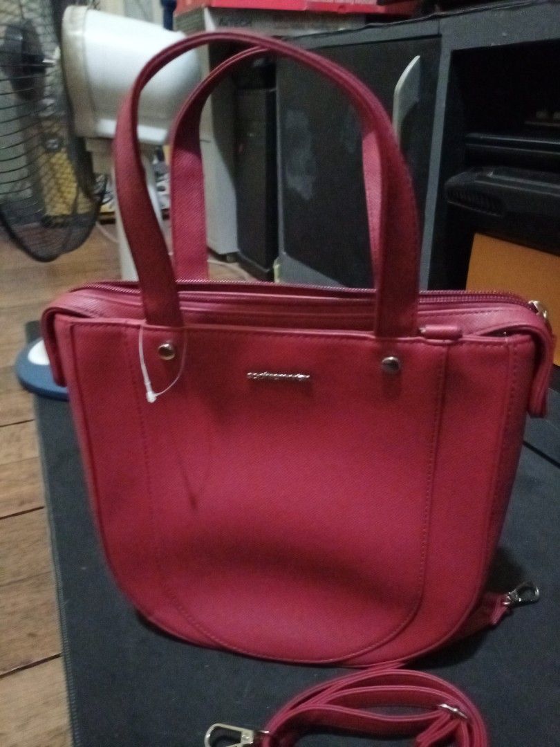 Red Shoulder Bag with Detachable Strap (Category: Shoulder Bags) located in Manila. Submitted by luckyeagle-7ff8 (Listing ID 1468878959, Image 2). Description: - Color: Bright red - Material: Clean textured faux leather with silver hardware - Design: Structured shape with a rounded base and secure top zipper closure - Straps: Dual top handles and a detachable long strap - Usage: Ideal size for daily essentials or casual outings.