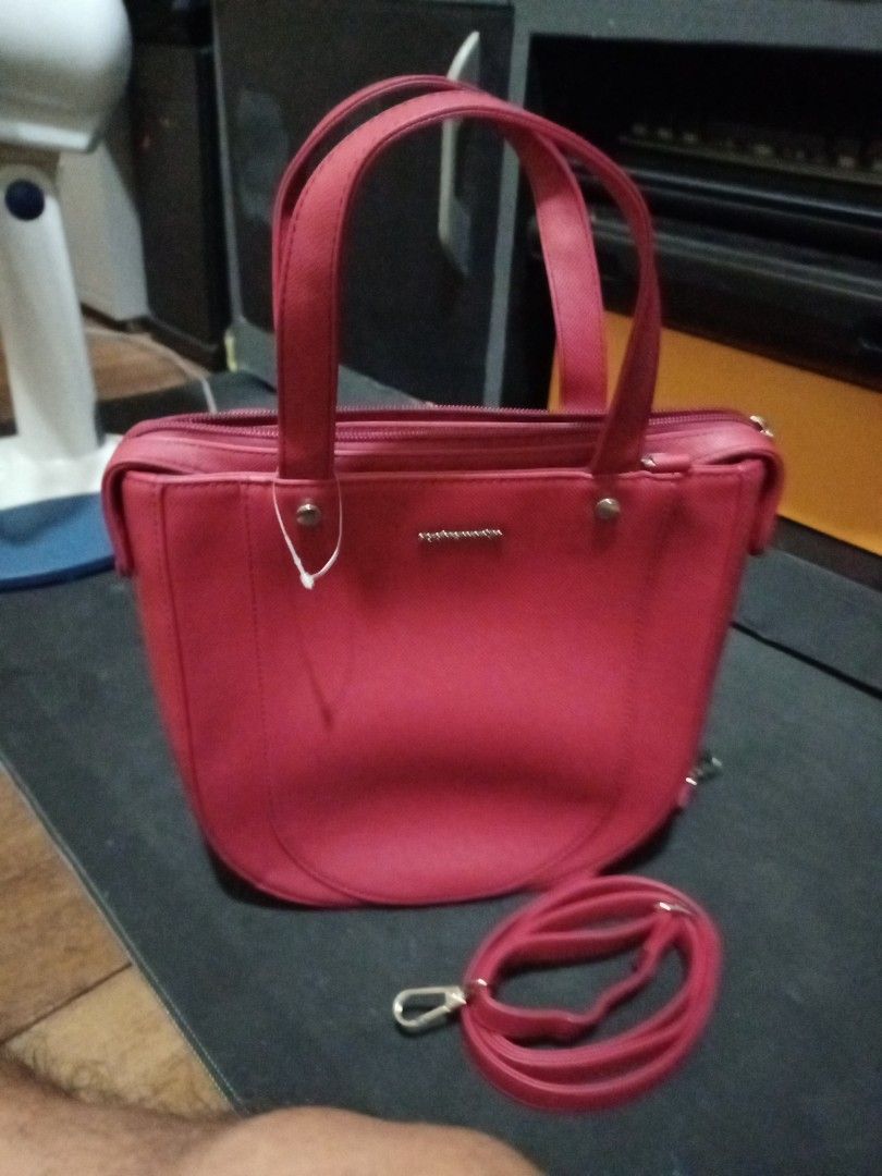 Red Shoulder Bag with Detachable Strap (Category: Shoulder Bags) located in Manila. Submitted by luckyeagle-7ff8 (Listing ID 1468878959, Image 1). Description: - Color: Bright red - Material: Clean textured faux leather with silver hardware - Design: Structured shape with a rounded base and secure top zipper closure - Straps: Dual top handles and a detachable long strap - Usage: Ideal size for daily essentials or casual outings.