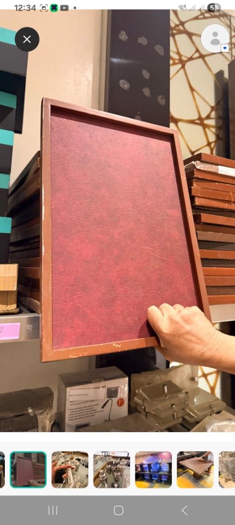 Red textured display tray or frame (Category: Frames & Pictures) located in Las Pinas. Submitted by jesus1smysavi0r (Listing ID 1468743102, Image 1). Description: - Textured red leatherette surface with a classic brown wooden frame - Handheld, rectangular design ideal for menus, table displays, or photo presentations - Condition: Good, with only minor scuffs on the bottom corner - Multiple identical pieces available in stock - Send a message for 