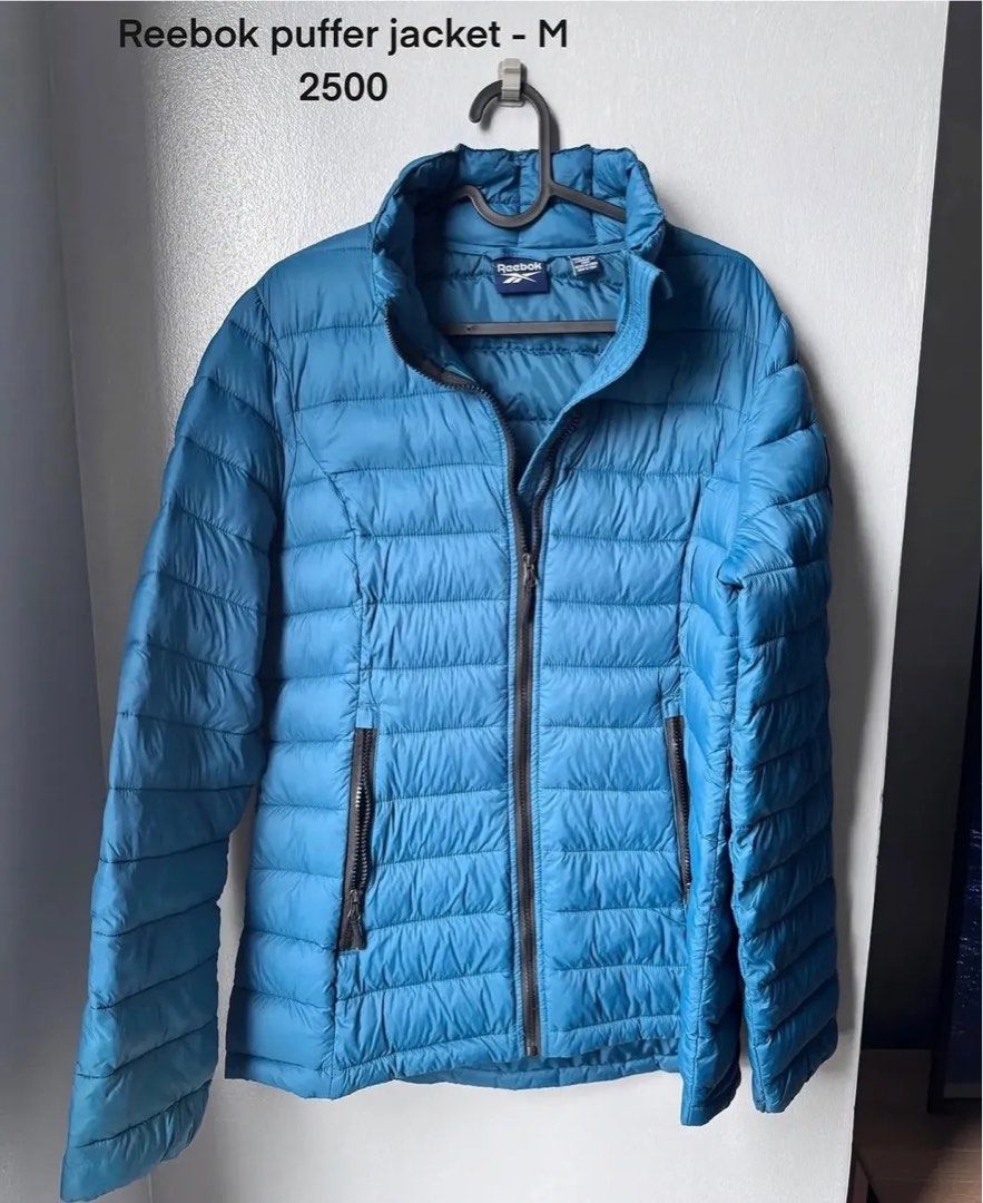 Reebok puffer jacket - M (Category: Coats, Jackets and Outerwear) located in Mandaluyong City. Submitted by closetshoponline (Listing ID 1468714555, Image 1). Description: - Brand/Model: Reebok puffer jacket - Color: Bright blue - Size: Medium - Design: Quilted with a stand-up collar - Closure & Pockets: Full front zip and two zippered side pockets - Condition: Clean, well-maintained, and great for chilly weather.