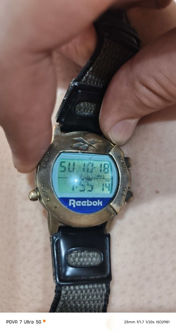 Reebok Vintage Watch PH movement (Category: Men's Watches) located in Quezon City. Submitted by junseller18 (Listing ID 1468758579, Image 2). Description: Rare time piece, newly replaced battery (Toshiba CR2016 Oct 18, 2026) . -Scatches on the glass. (see actual photos) - Brand: Reebok (Vintage model with Philippines movement) - Display: Digital screen showing time, day, and date - Design: Brass-tone bezel with iconic Reebok logo at the top - Str