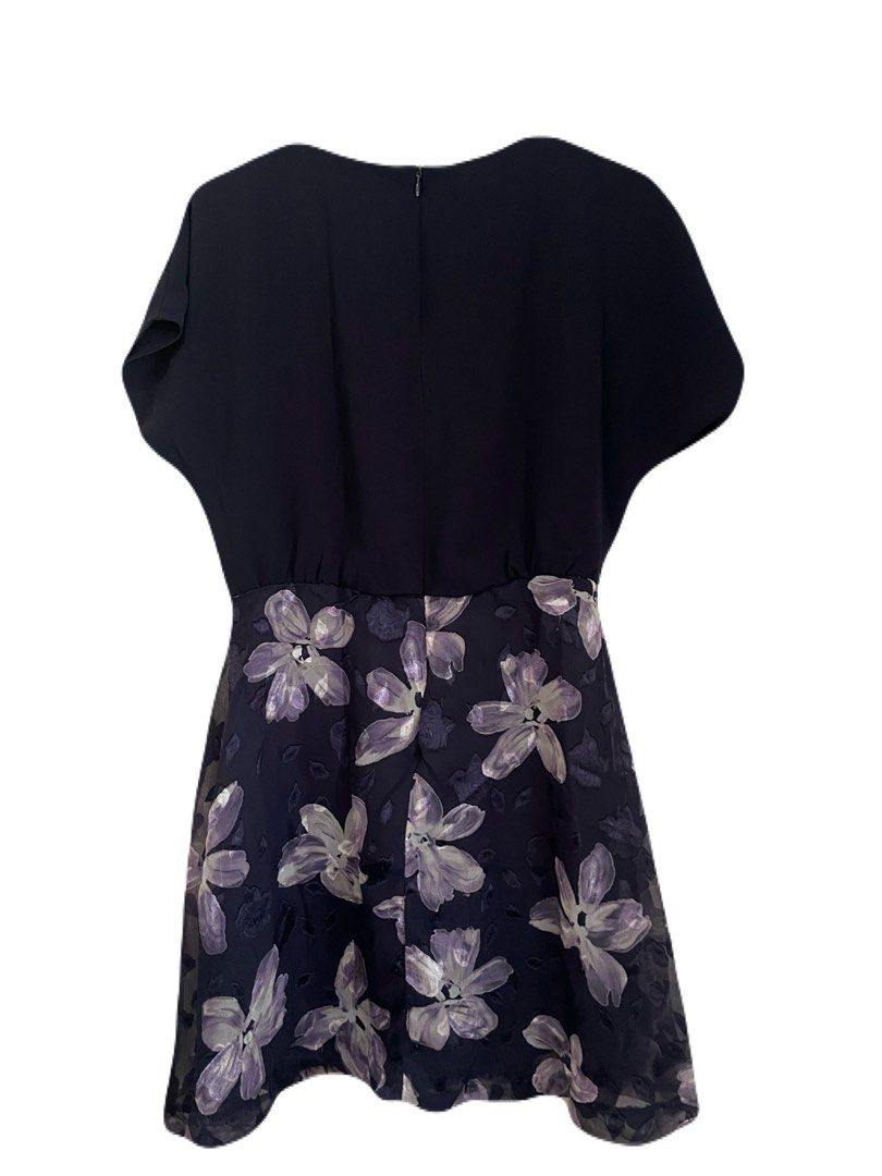 Navy Blue Floral Dress (Category: Dresses) located in Makati City. Submitted by nikarchives (Listing ID 1468749930, Image 3). Description: - Brand: REFILL (Made in Korea) - Design: Navy blue top with a purple floral pattern skirt - Details: Short cap sleeves, round neckline with a decorative shoulder button, and back zip closure - Care: Dry clean only - Style: Cute and versatile for casual outings or work.