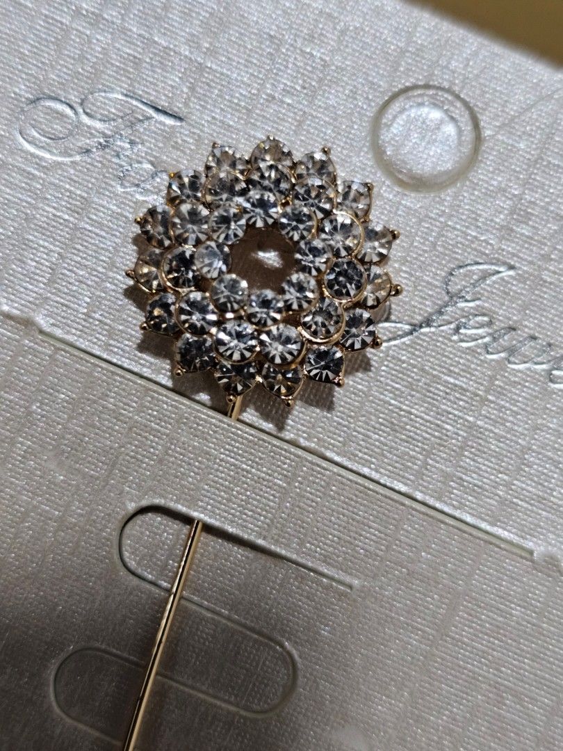 Rhinestone Flower Lapel Stick Pin Brooch (Category: Brooches) located in Caloocan City. Submitted by smart_shoppers_ville (Listing ID 1468803208, Image 3). Description: - Elegant gold-tone brooch with a layered floral rhinestone cluster - Brand new, mounted on the original display card - Features a secure pin back closure with a safety cap - Versatile accessory for scarves, shawls, and jackets - Adds a sparkling touch to your everyday look.