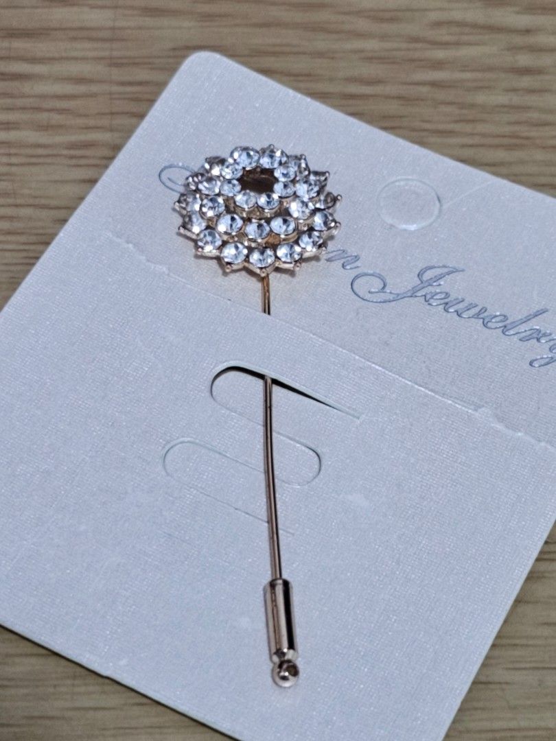 Rhinestone Flower Lapel Stick Pin Brooch (Category: Brooches) located in Caloocan City. Submitted by smart_shoppers_ville (Listing ID 1468803208, Image 1). Description: - Elegant gold-tone brooch with a layered floral rhinestone cluster - Brand new, mounted on the original display card - Features a secure pin back closure with a safety cap - Versatile accessory for scarves, shawls, and jackets - Adds a sparkling touch to your everyday look.
