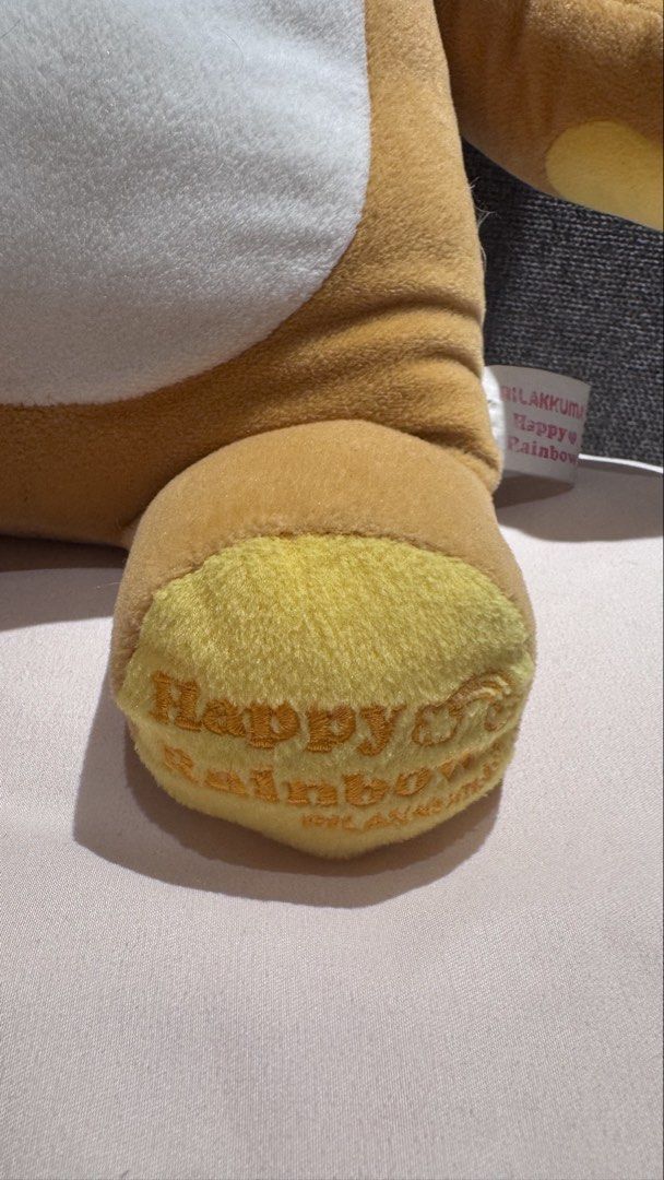Rilakkuma Happy Rainbow Plush Doll (Category: Plushies & Soft Toys) located in Mandaluyong City. Submitted by maelovestoshop (Listing ID 1468875847, Image 3). Description: - Authentic Large Rilakkuma Happy Rainbow series plush toy - Super soft brown fur with white belly and yellow ear/foot accents - Features cute zipper-like embroidery detail down the back - Embroidered text on foot pad with original side tag attached - Pristine condition: clean 