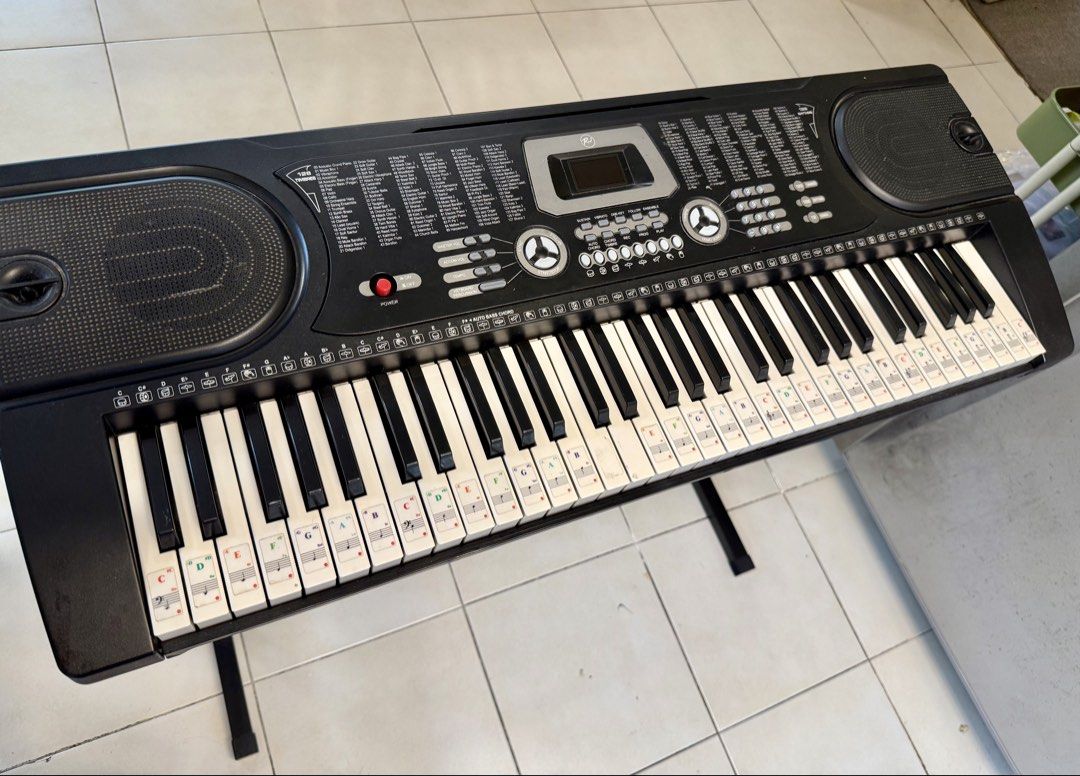 RJ Electronic Keyboard with Stand (Category: Musical Instruments) located in Pasig City. Submitted by alenatw (Listing ID 1468757914, Image 2). Description: RJ Tonemaster Keyboard Piano - Fully operational black electronic keyboard with built-in speakers and digital screen - Used but good condition, all keys 100% working. - Includes a sturdy metal X-stand - Full specifications in the last photo - Note sticker guides attached to the keys, perfect 