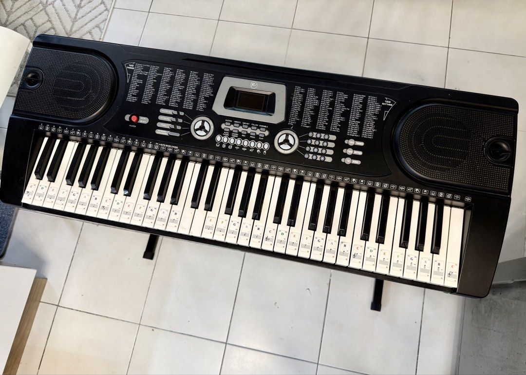 RJ Electronic Keyboard with Stand (Category: Musical Instruments) located in Pasig City. Submitted by alenatw (Listing ID 1468757914, Image 3). Description: RJ Tonemaster Keyboard Piano - Fully operational black electronic keyboard with built-in speakers and digital screen - Used but good condition, all keys 100% working. - Includes a sturdy metal X-stand - Full specifications in the last photo - Note sticker guides attached to the keys, perfect 