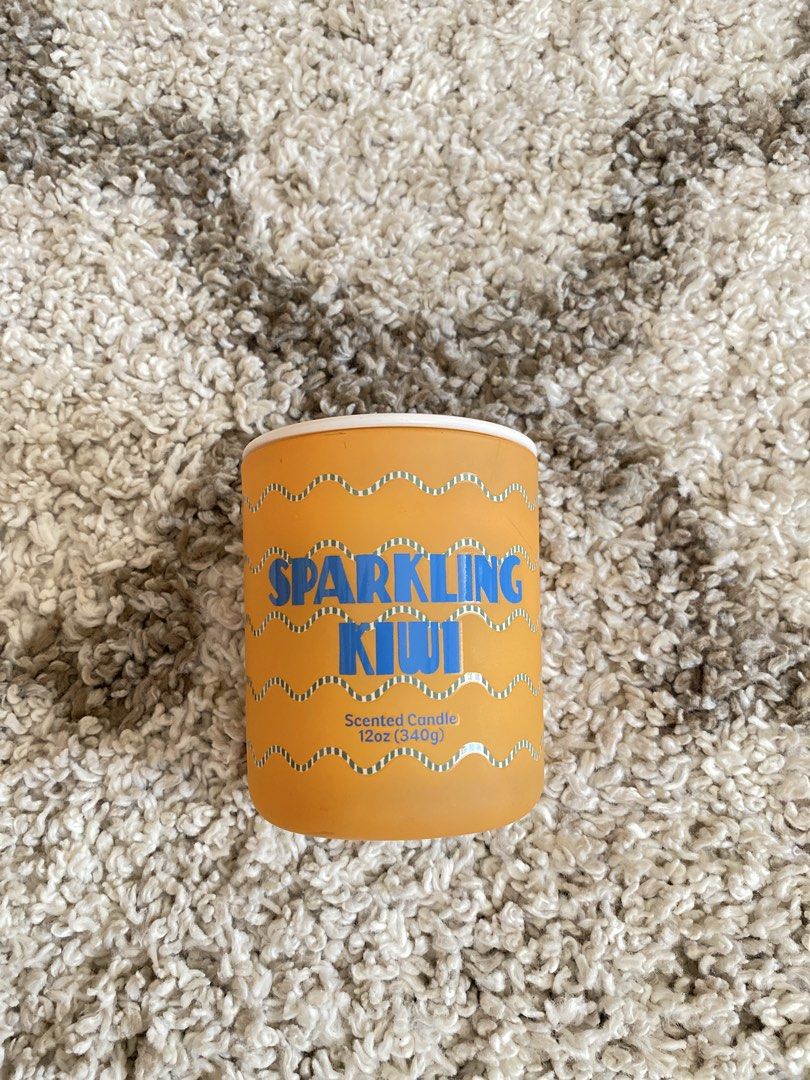 Room Essentials Sparkling Kiwi Scented Candle 12oz (Category: Home Fragrance) located in Batangas. Submitted by lux_kimmy (Listing ID 1468843324, Image 1). Description: Room Essentials jar candle in Sparkling Kiwi scent. 12 ounces / 340 grams weight. Orange frosted glass container with matching lid. White wax, single wick design. Never burned, wick and wax completely untouched. Great size for any room..