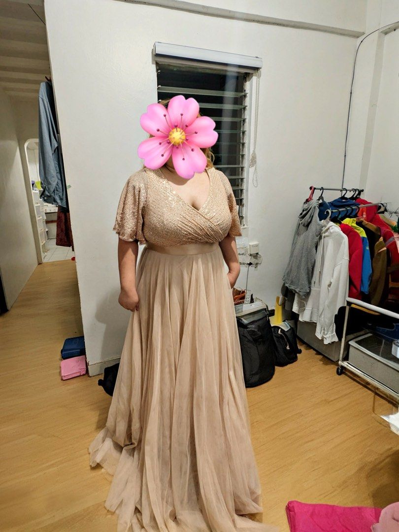 Rose gold sequin v-neck long evening gown (Category: Evening dresses & gowns) located in Cainta. Submitted by moonshoppee (Listing ID 1468755318, Image 1). Description: - Color: Rose gold top with matching nude tulle skirt - Design: V-neck, short flutter sleeves, wraparound style bodice with gentle pleats, and a defined waistband - Length: Long, flowing hemline - Condition: Worn once for a formal event, freshly washed, and carefully stored - Perf