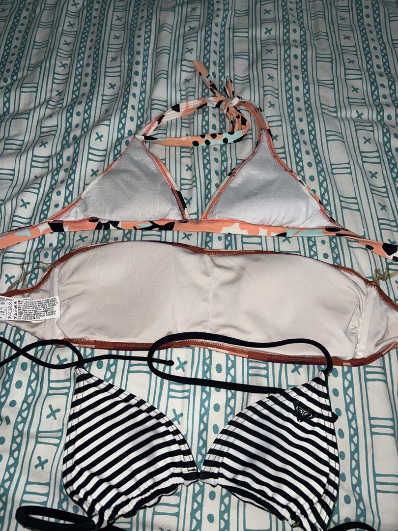 Roxy Bikini Tops Bundle Set of Three (Category: Bikinis & Swimsuits) located in Marikina City. Submitted by ash_2 (Listing ID 1468732176, Image 2). Description: - Bundle of 3 versatile bikini tops - Top 1: Peach floral and abstract print with halter neck straps - Top 2: Forever 21 Burgundy, pink striped strapless bandeau - Top 3: Reversible black top with Roxy graphic logo on front and stripes on the back - Soft removable padding included - Great