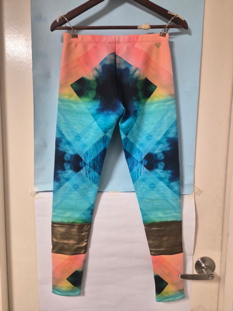 Roxy Geometric Pattern Athletic Leggings (Category: Activewear) located in Manila. Submitted by prelovedbyc.hannah (Listing ID 1468782796, Image 2). Description: - Brand: Roxy - Design: Bold geometric and tie-dye pattern in blue, pink, and yellow with metallic bronze ankle cuffs - Material: High-stretch polyester and elastane blend - Size: M - with yellowish stains please refer to the images.