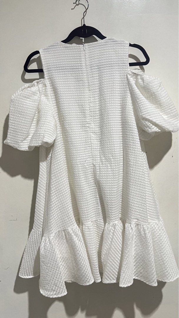 ruffle mini dress with bows (Category: Dresses) located in Cabuyao City. Submitted by calmstorm.0108 (Listing ID 1468836422, Image 2). Description: - Color & Pattern: White with a subtle all-over checkered texture - Design: Cold shoulder cutouts, puff sleeves, and cute bow details on the shoulders - Details: Flounce hem for a fun bounce and convenient back zipper closure - Best for: Casual outings or dates Medium to large size.